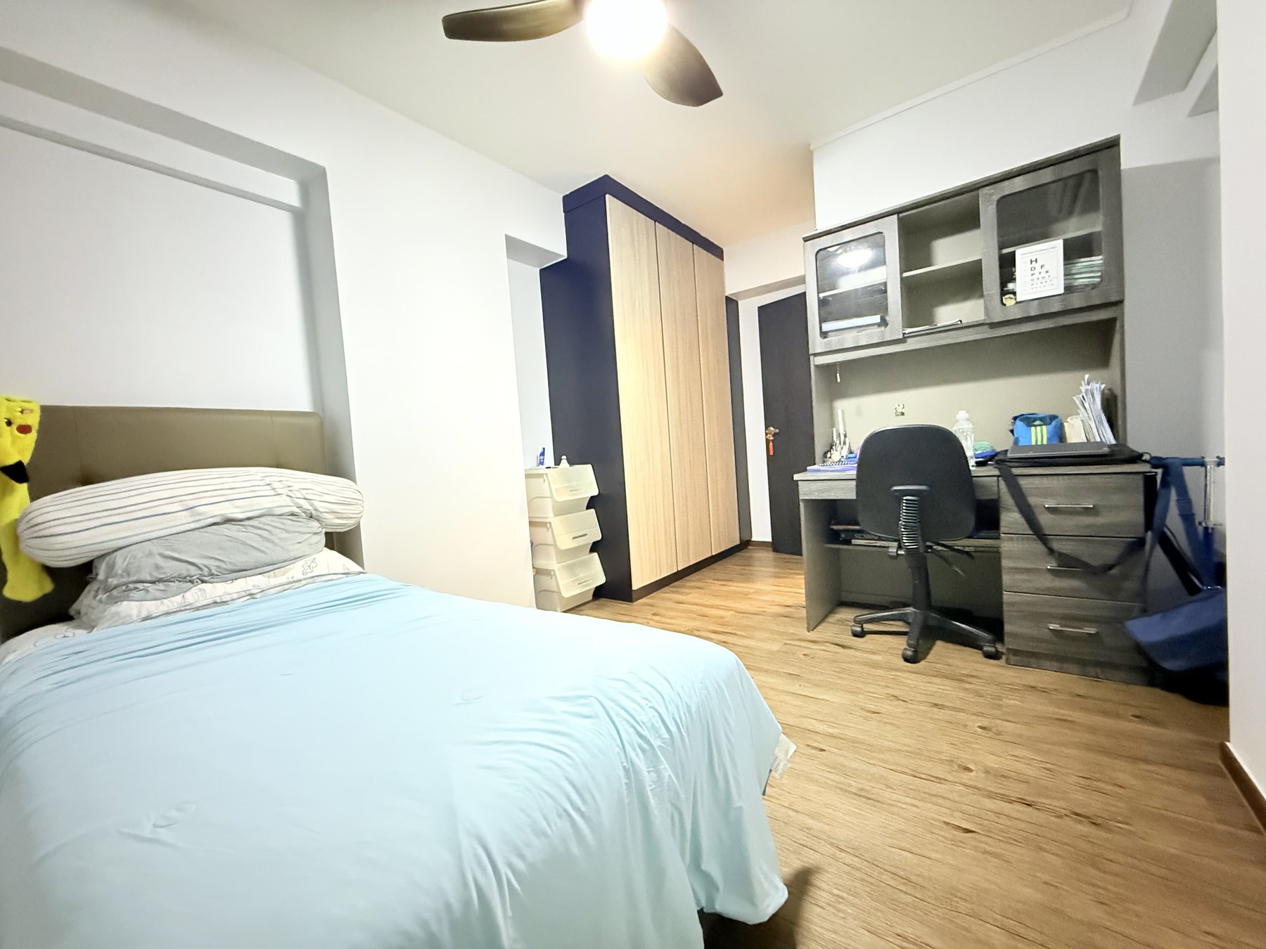 Bedroom with study desk and built-in wardrobe in the Toa Payoh HDB flat