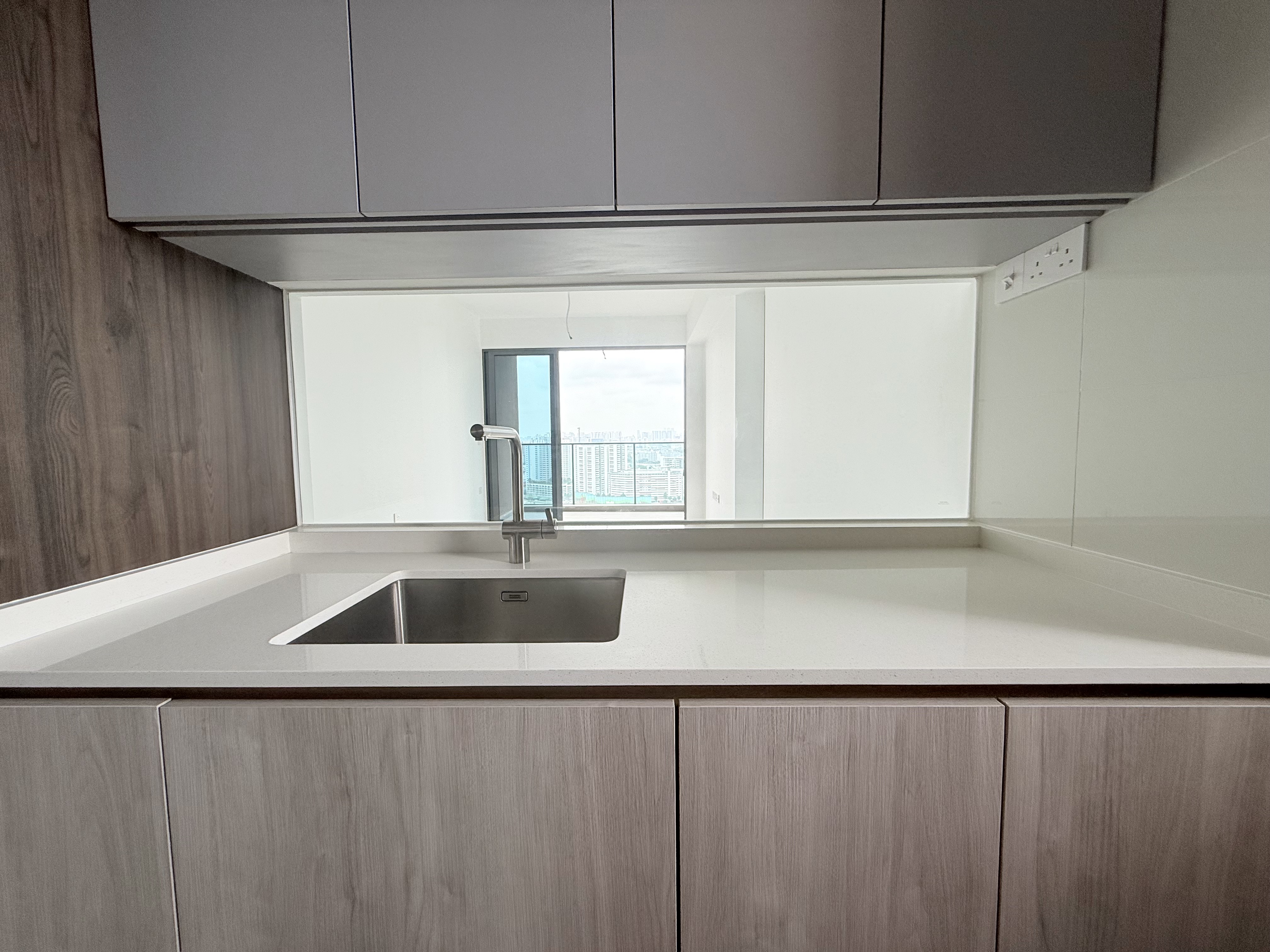 Open kitchen counter at AMO Residence facing the living area