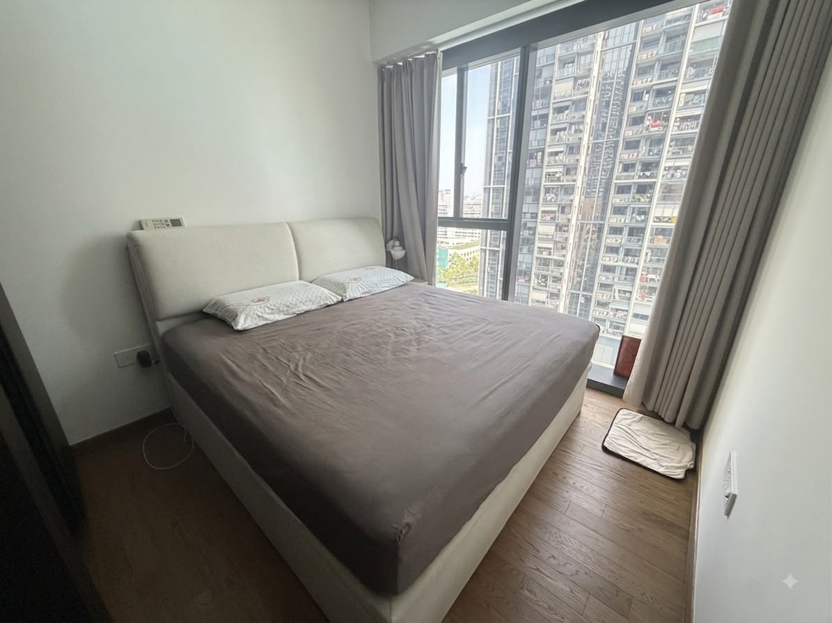 Bedroom with full-height window in the Parc Clematis pool-view unit